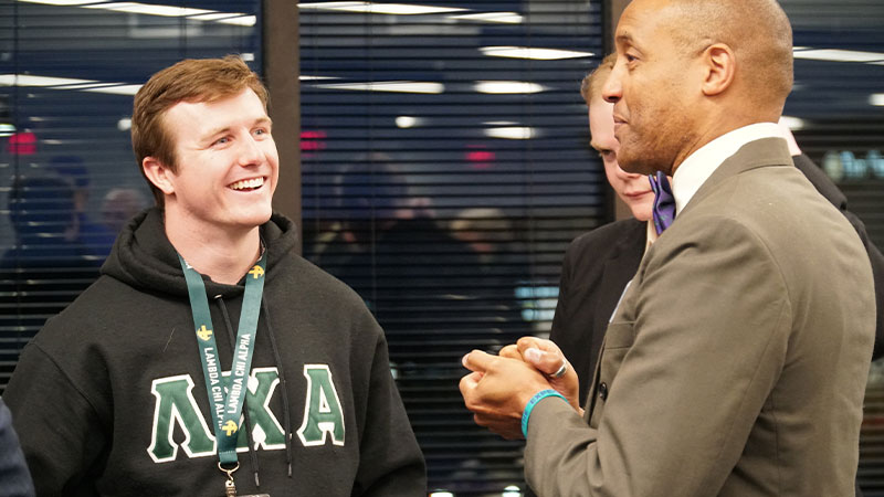 Student talking with man Student talking with man