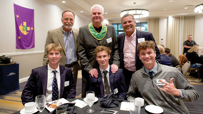 Students and faculty posing at dinner Students and faculty posing at dinner